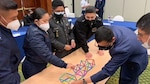 Students build bridge on table.