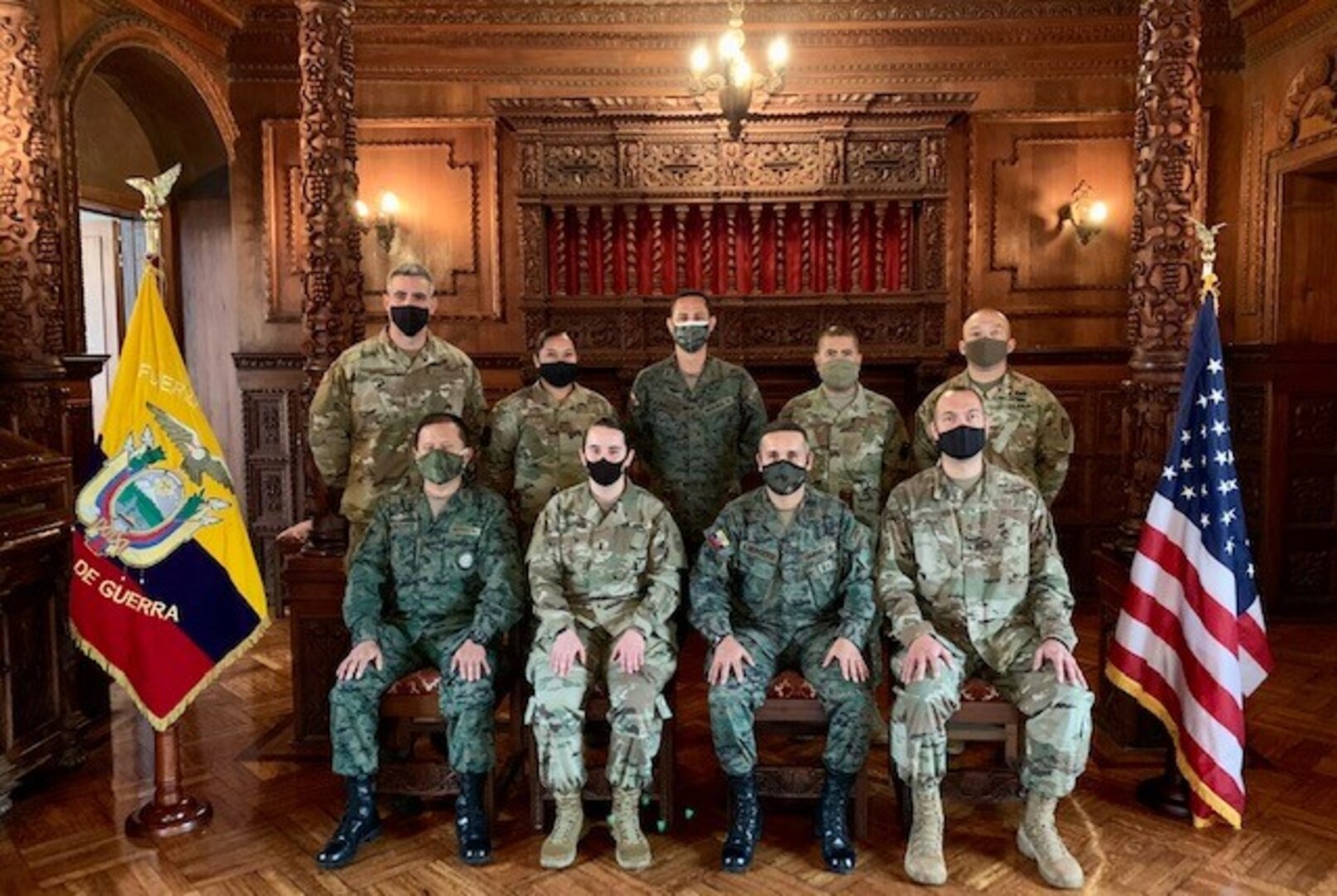 Eight military members pose for photo.