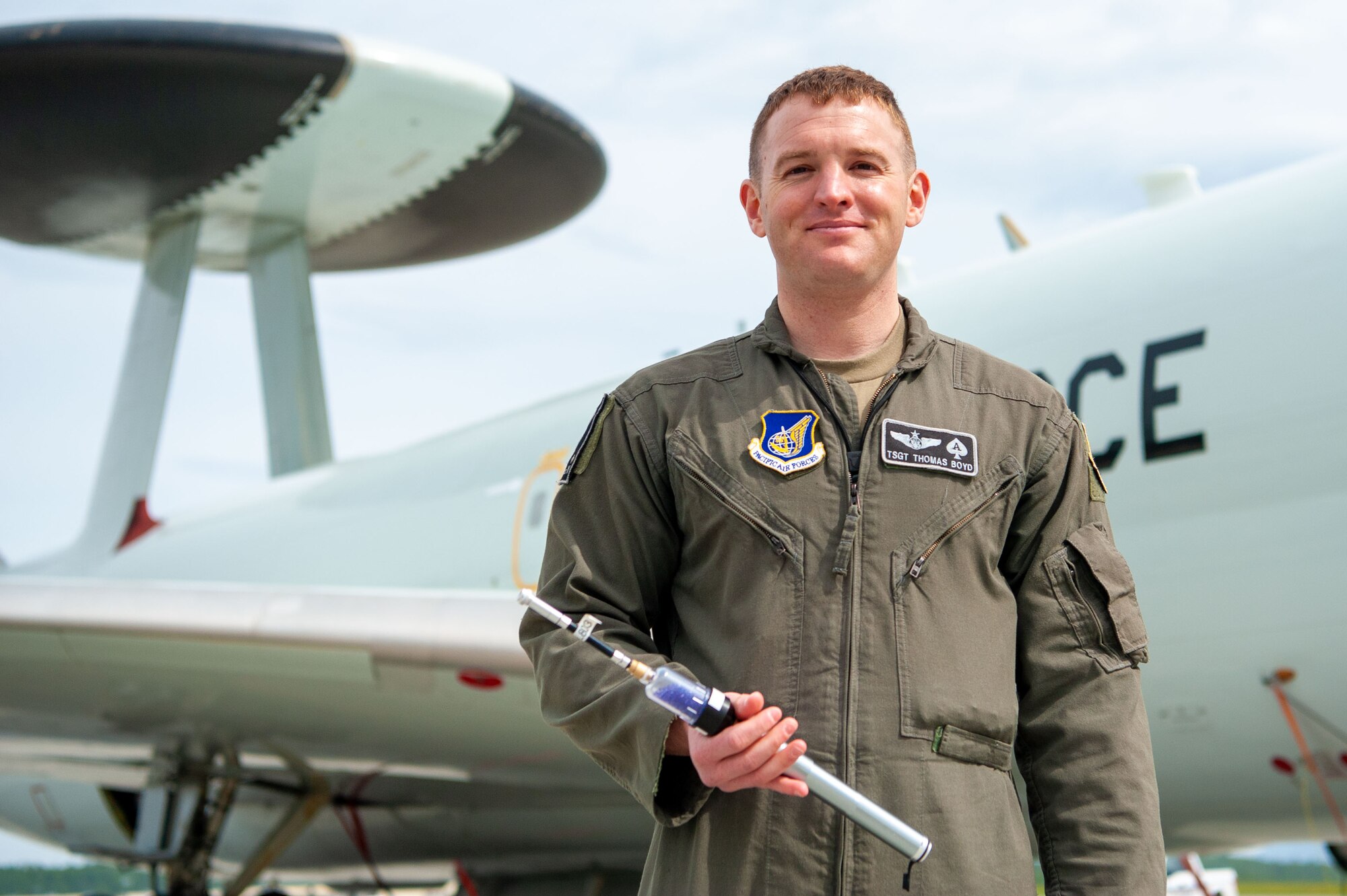 U.S. Air Force Tech. Sgt. Thomas Boyd, the 3rd Wing noncommissioned officer in charge of Agile Combat Employment, poses for a photo holding his solution to the radio deficiency in the E-3 Sentry Airborne Warning and Control System (AWACS) aircraft at Joint Base Elmendorf-Richardson, Alaska, May 27, 2021. The pump created increases the AWACS’ communications capabilities in the air, and reduces the amount of equipment that aircrew and maintenance are required to carry to and from the aircraft.