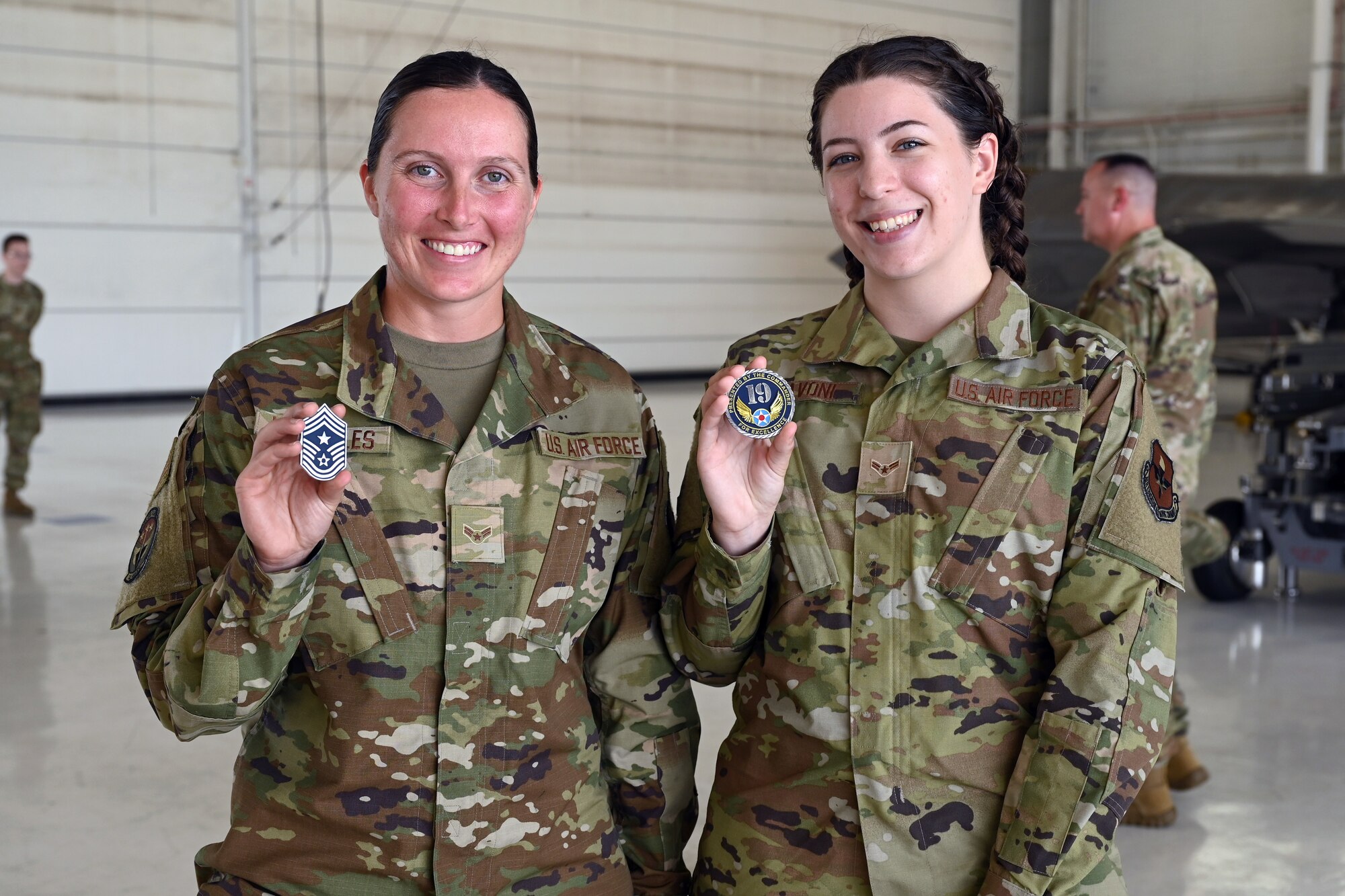 Two Airmen get coined by 19th Air Force leadership