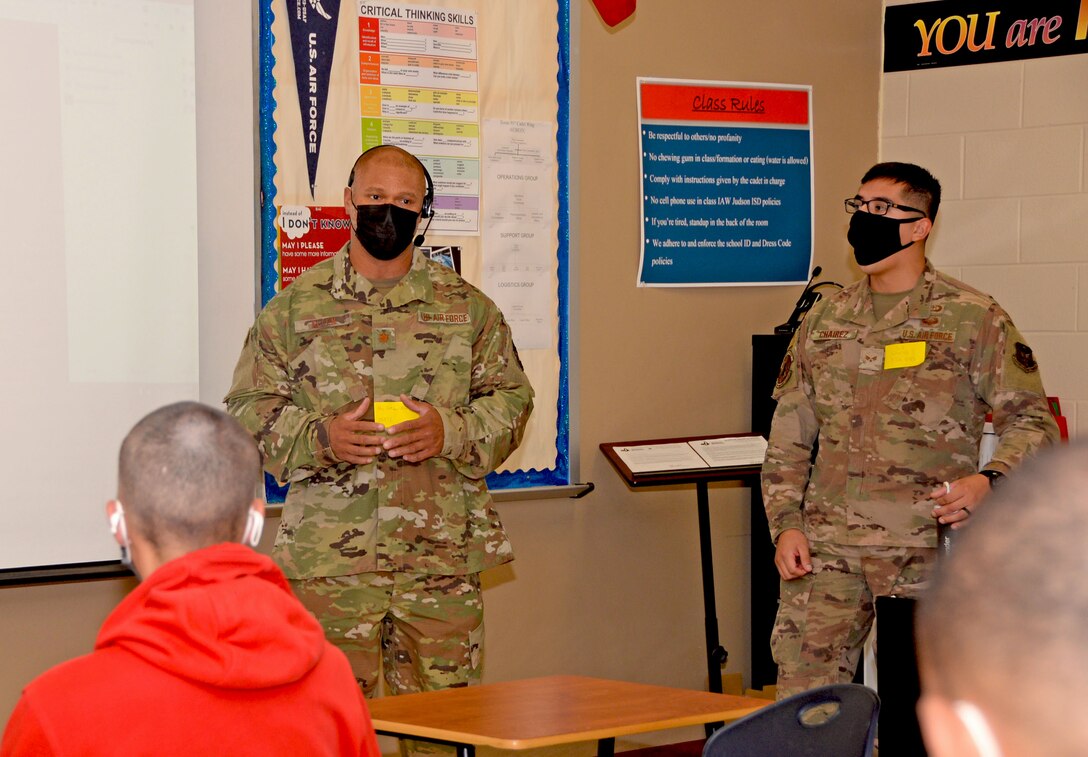 Maj. Nathan Allen, 960th Cyberspace Wing operations support flight, and Senior Airman Manuel Chairez, 426th Network Warfare Squadron cyber operator, talk with Junior Reserve Officer Training Corps students at Judson High School, Converse, Texas, May 19, 2021. (U.S. Air Force photo by Samantha Mathison)