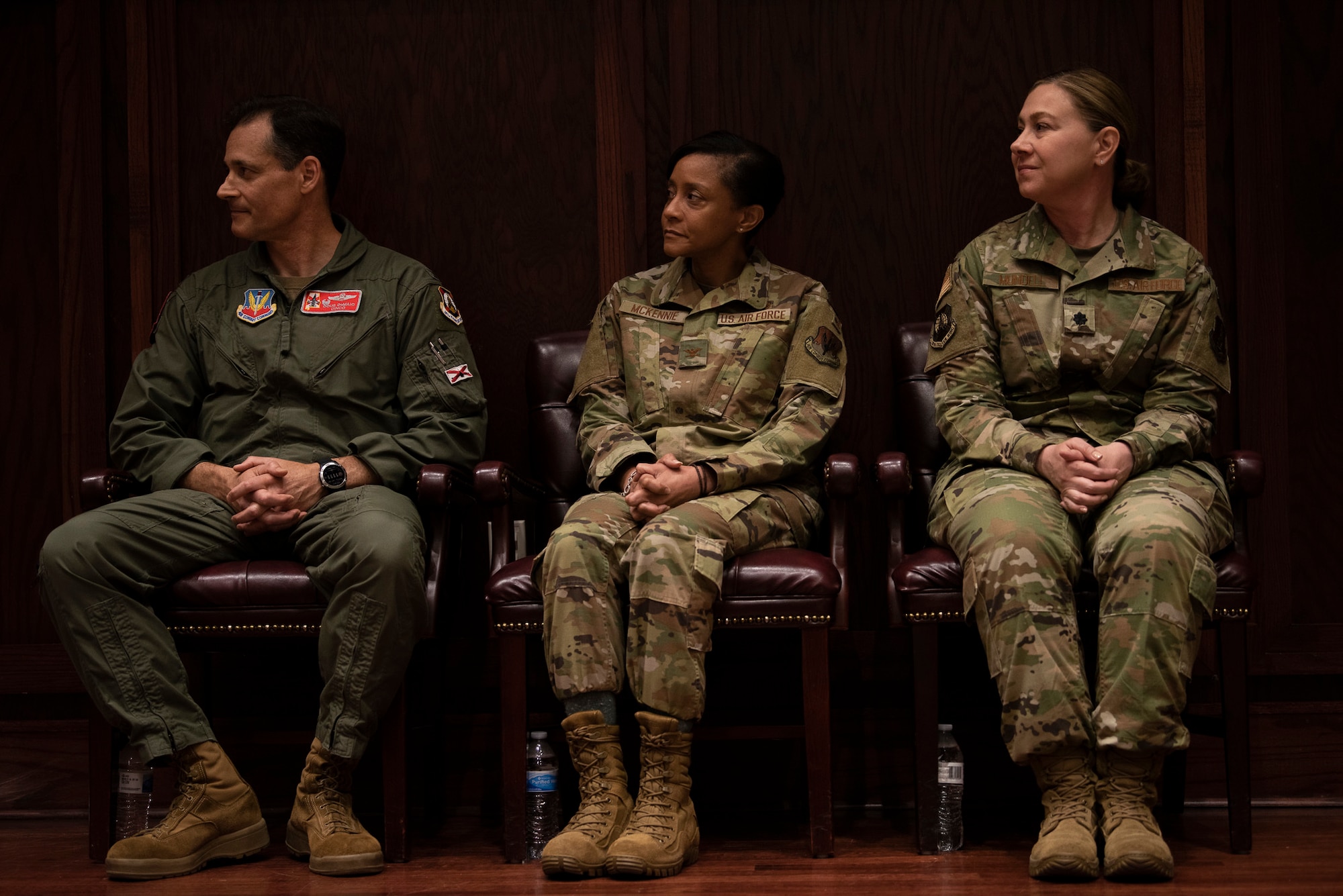 Col. DeMaio, Col. McKennie, and Lt. Col. Mundell sit during a medical group change of command ceremony.