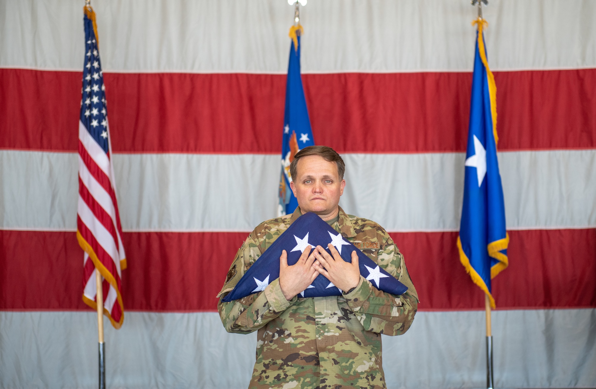 Chief Master Sgt. Paul Strazz, Command Chief of the 419th Fighter Wing, prepares to hand off the flag symbolizing the transfer of responsibilities to the next generation of Airmen during a retirement ceremony June 6, 2021 at Hill Air Force Base, Utah.
