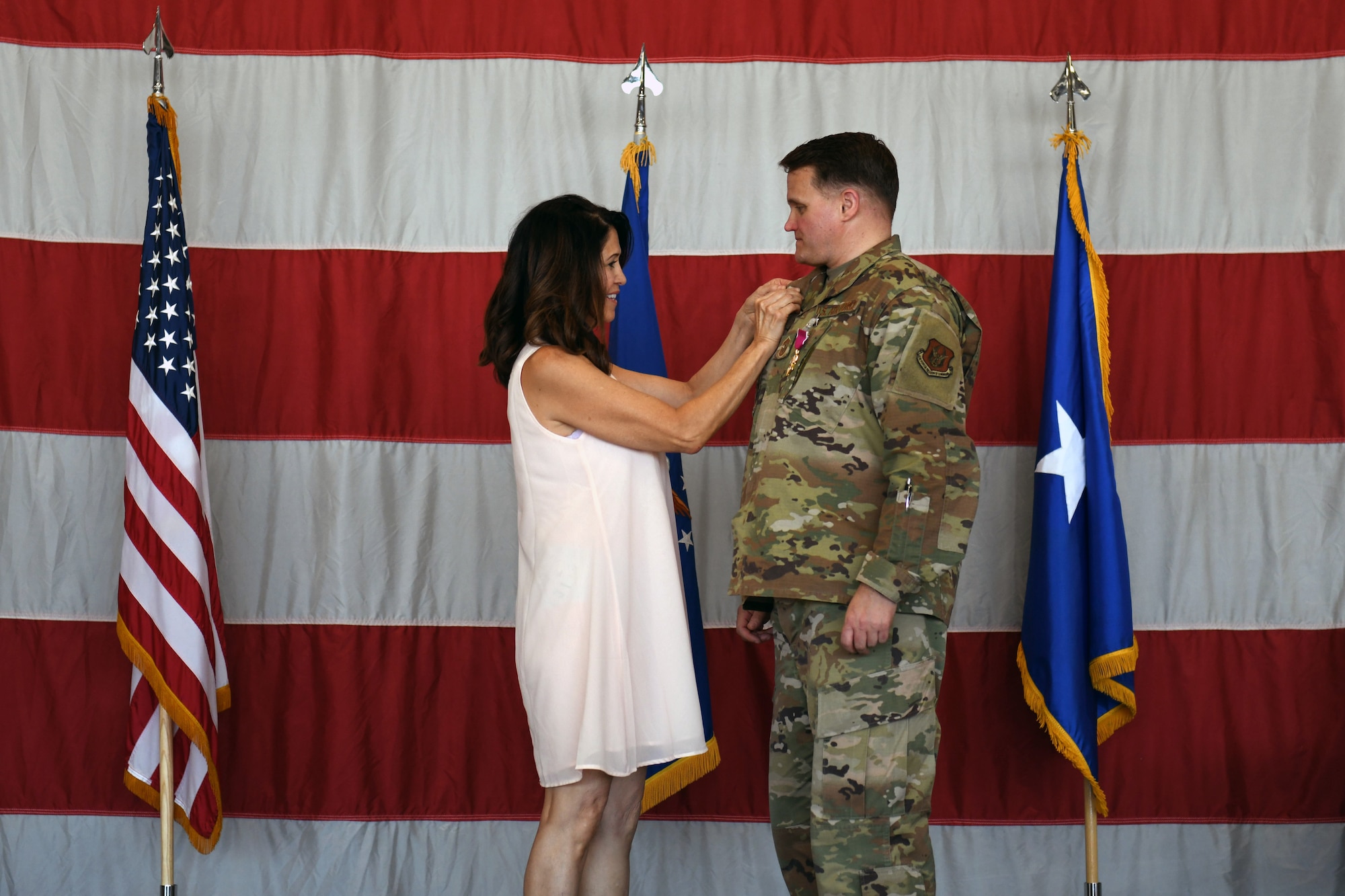 Bonnie Tesch Strazz, spouse of Chief Master Sgt. Paul Strazz, places a pin on her husband’s lapel to celebrate his retirement from the Air Force Reserve June 6, 2021 at Hill Air Force Base, Utah. Strazz served 30 years in the Air Force, including 23 years in the Air Force Reserve.