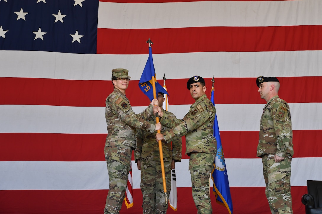 Commanders pose for a photo during a ceremony.