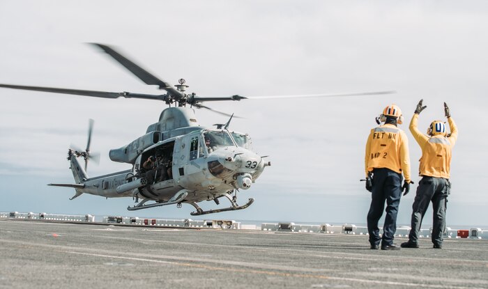 U.S. Sailors assigned to amphibious assault ship USS Essex signal a UH-1Y Venom with Marine Medium Tiltrotor Squadron 165, 11th Marine Expeditionary Unit, during takeoff from Essex, May 13, 2021. Marines and Sailors of the Essex Amphibious Ready Group and the 11th MEU are conducting routine training off the coast of southern California.