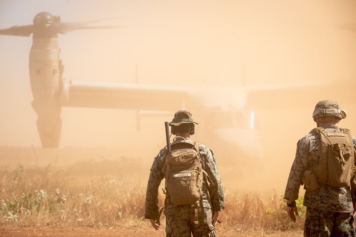 U.S. Marine Corps Staff Sgt. Benjamin Dampier, left, an air traffic controller, and Cpl. Ty Cochrane, an air support operations operator, both with Marine Medium Tiltrotor Squadron 363, Marine Rotational Force – Darwin, watch an MV-22B Osprey land at Point Fawcett, NT, Australia during exercise Crocodile Response, May 27, 2021. Exercise Crocodile Response tested the ability of MRF-D and the Australian Defence Force to provide disaster relief in the Indo-Pacific region. The rotational deployment of U.S. Marines affords a combined training opportunity with Australia and improves cooperation and integration between the two country’s forces.