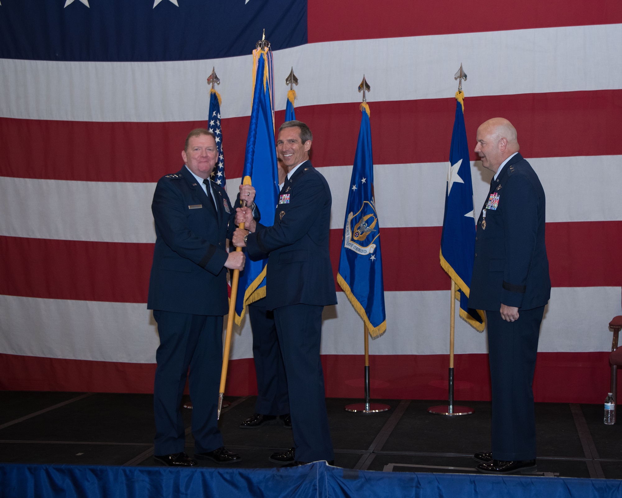 Lt. Gen. Richard Scobee and Maj. Gen. Bryan Radliff pause for a picture during the passing of the Tenth Air Force unit colors, signifying the change of command.
