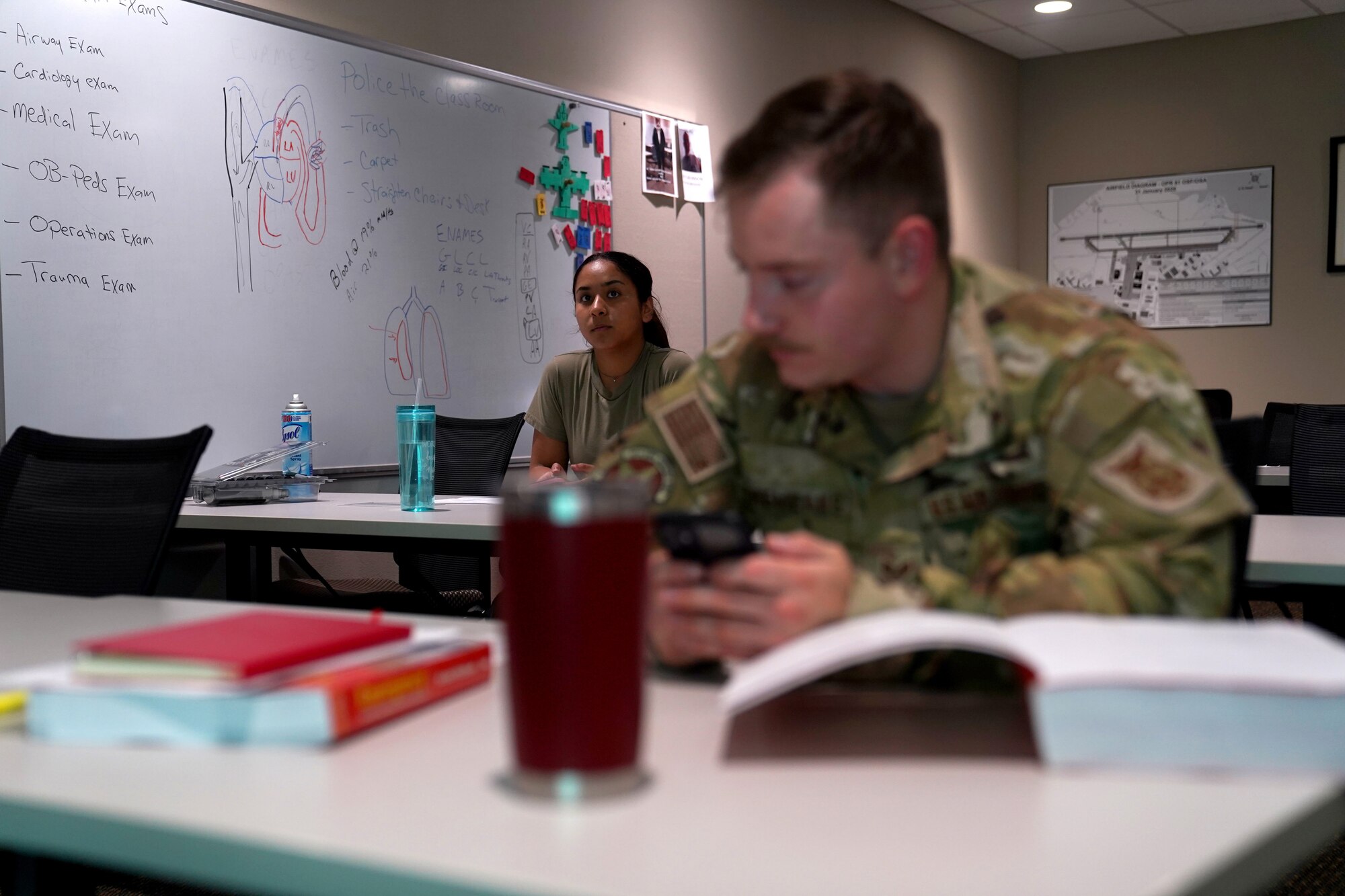 U.S. Air Force Airman 1st Class Cinthia Juarez, 81st Civil Engineer Squadron driver operator, and Airman 1st Class Kyle Cremeans, 81st CES crew chief, prepare for class inside the fire station at Keesler Air Force Base, Mississippi, June 2, 2021. The Keesler Fire Department responds to medical emergencies on and around base 24 hours a day. (U.S. Air Force photo by Senior Airman Seth Haddix)