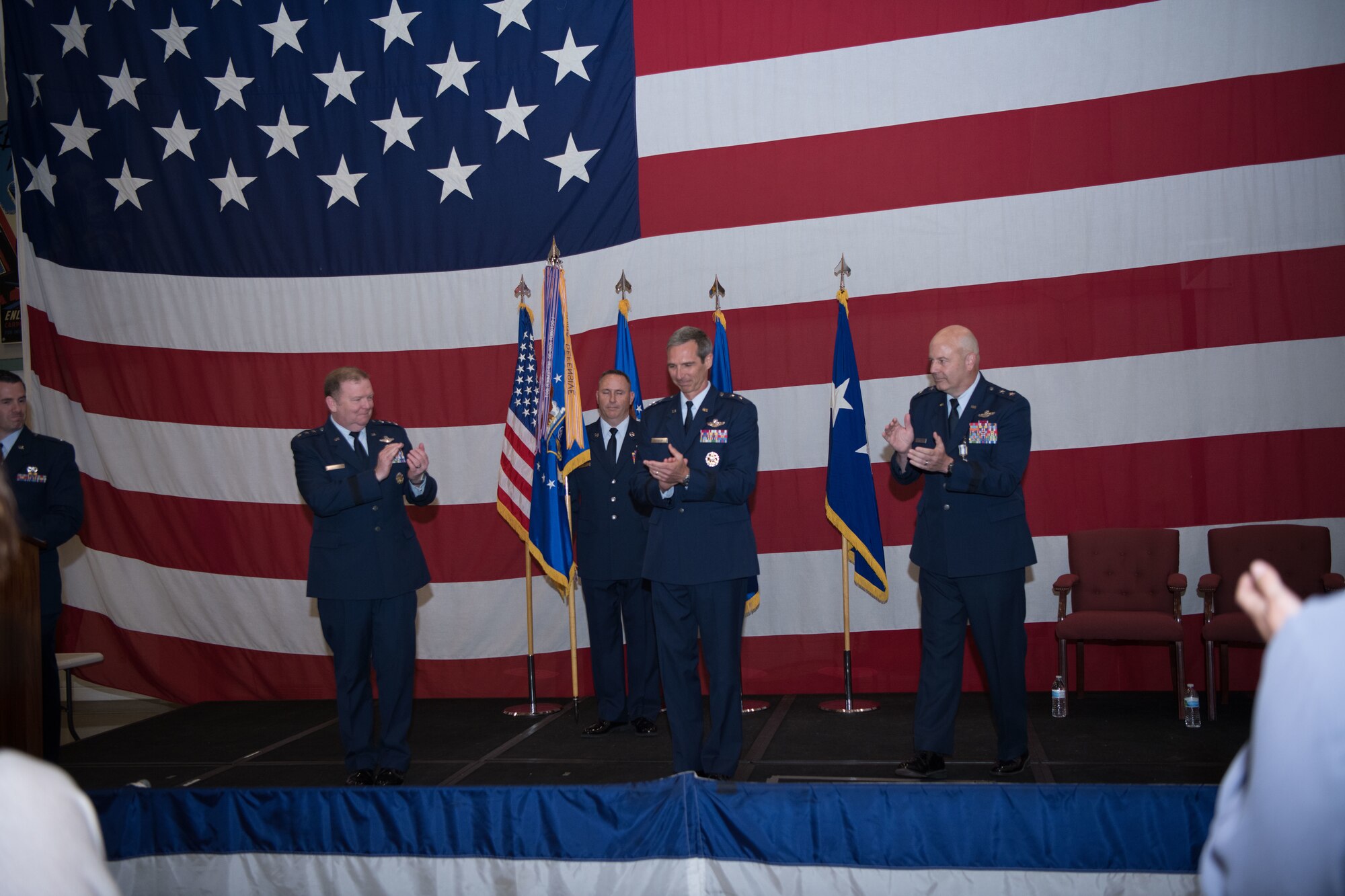 Maj Gen Bryan Radliff receives a round of applause after accepting command of Tenth Air Force.