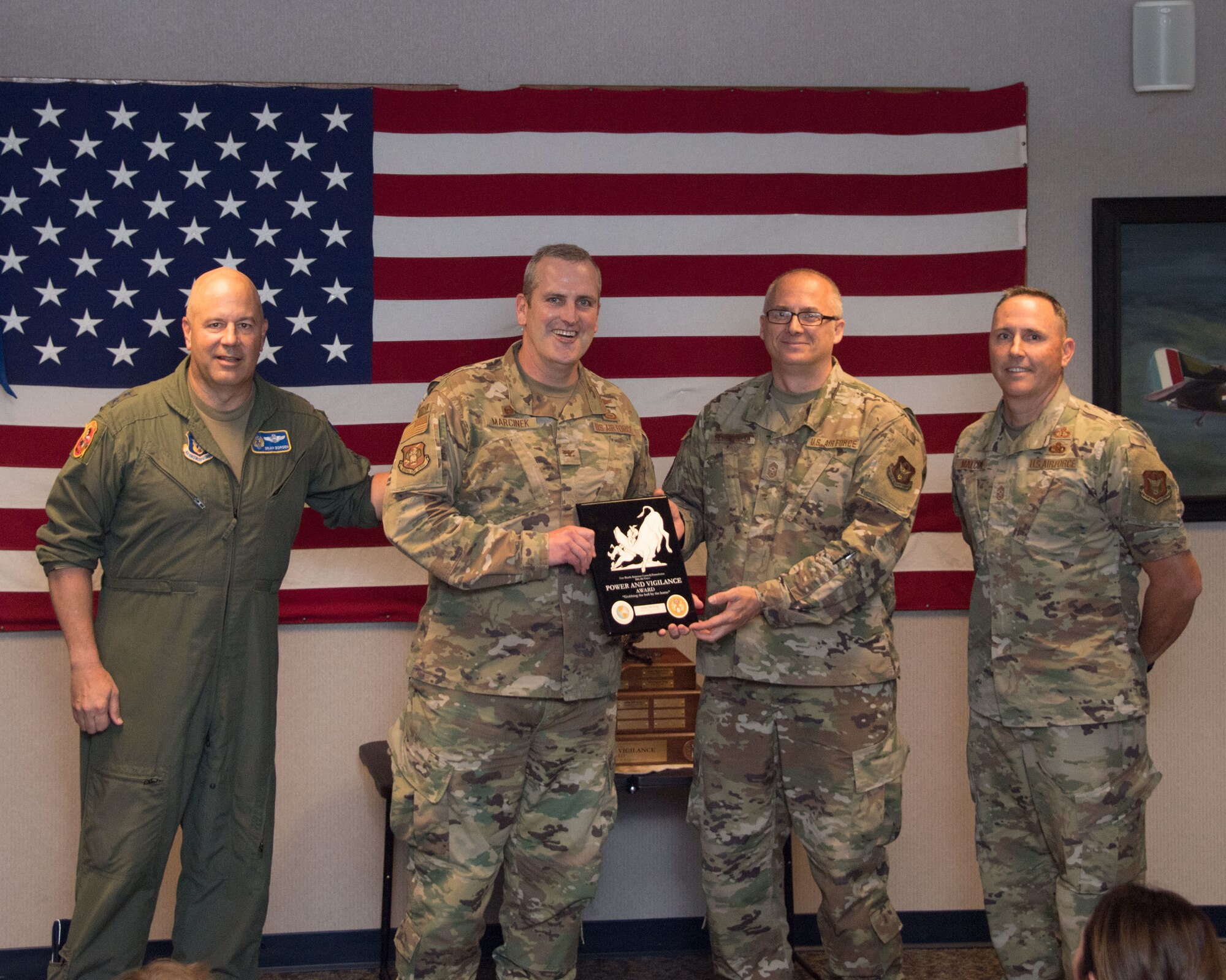 Maj. Gen. Brian Borgen, Tenth Air Force Commander and Chief Master Sgt. Jeremy Malcom, Tenth Air Force Command Chief, present the Power and Vigilance Award to Col. Joseph Marcinek, 655th Intelligence, Surveillance, and Reconnaissance Wing Commander and Chief Master Sgt. Bohdan Pywowarczuk II, 655th ISRW Command Chief.