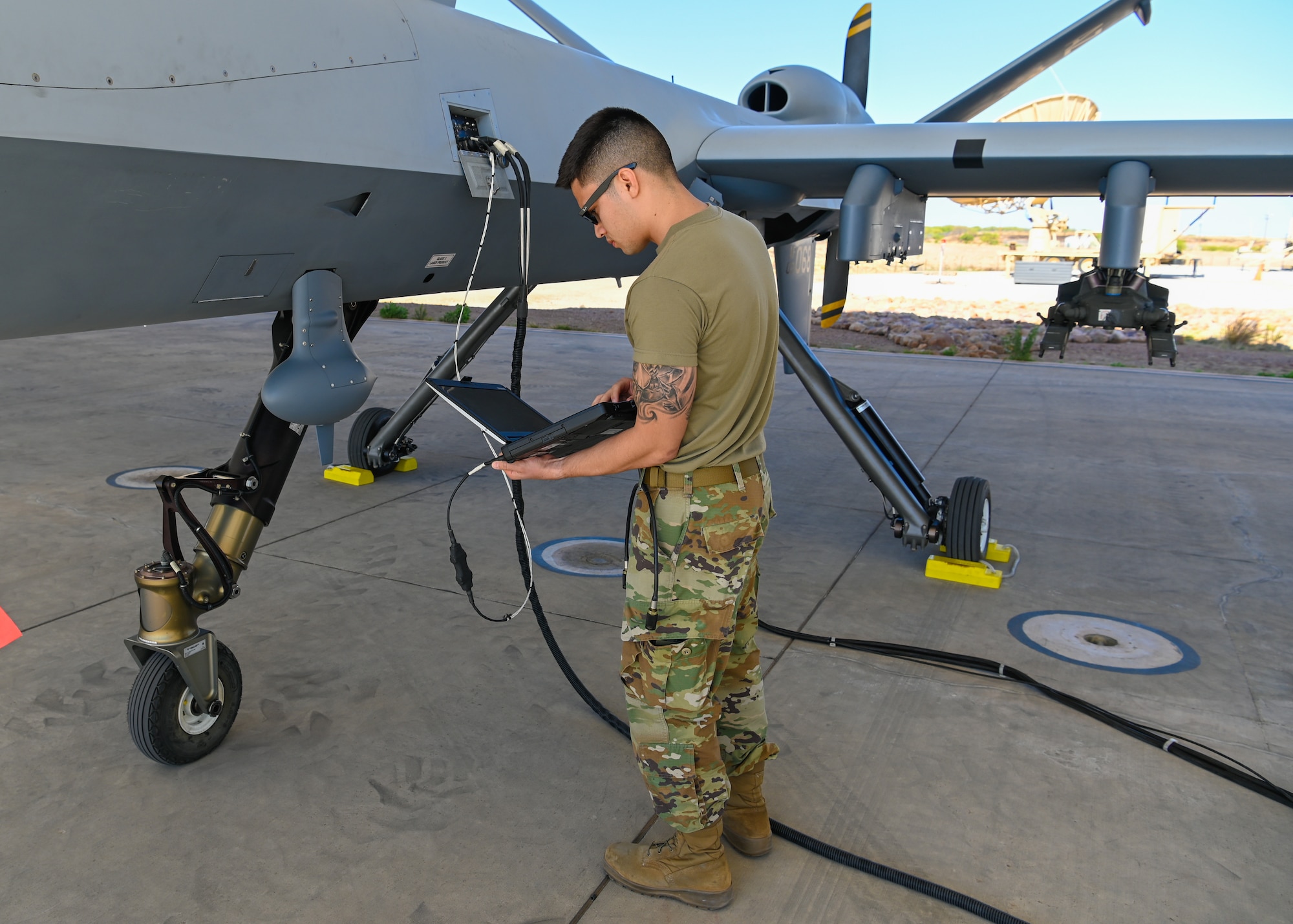 Staff Sgt. Jason Ayala, 214th Attack Group Avionics, performs a pre-flight software load onto an MQ-9 Reaper
