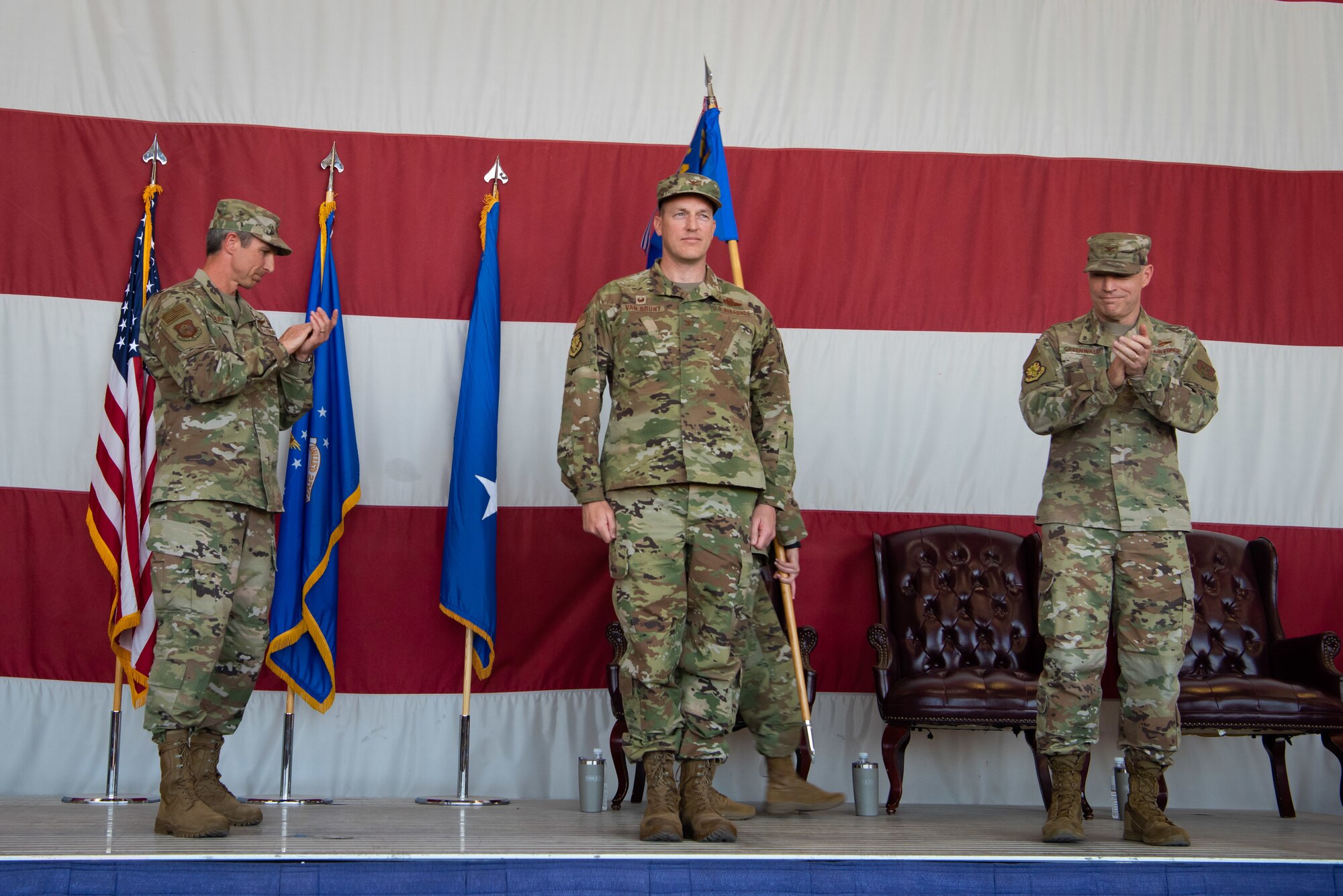 Maj. Gen. Bryan Radliff, 10th Air Force Commander and Col. Jim Greenwald, outgoing 944th Fighter Wing Commander, applaud Col. Mark Van Brunt, incoming 944th Fighter Wing Commander during the 944th FW change of command ceremony at Luke Air Force Base, Ariz., June 6, 2021. Friends, family, community members, members of the Archer-Ragsdale Arizona Chapter of Tuskegee airmen, and men and women of the 944th and 56th Fighter Wings attended the morning ceremony, presided over by Radliff.