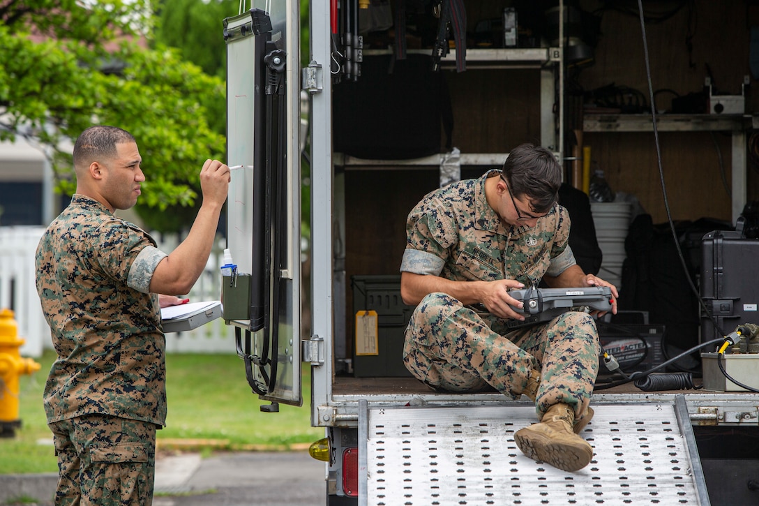 U.S. Marine Corps Staff Sgt. Jake Castro, (left), and Sgt. Anthony Negrete, (right), Explosive Ordnance Disposal technicians with Marine Corps Air Station Iwakuni EOD, conduct a improvised explosive device exercise aboard MCAS Iwakuni, Japan, May 19, 2021. This particular exercise was designed to allow EOD to utilize a robot in their arsenal, which allows them to engage explosives at a greater distance with no harm to Marines.