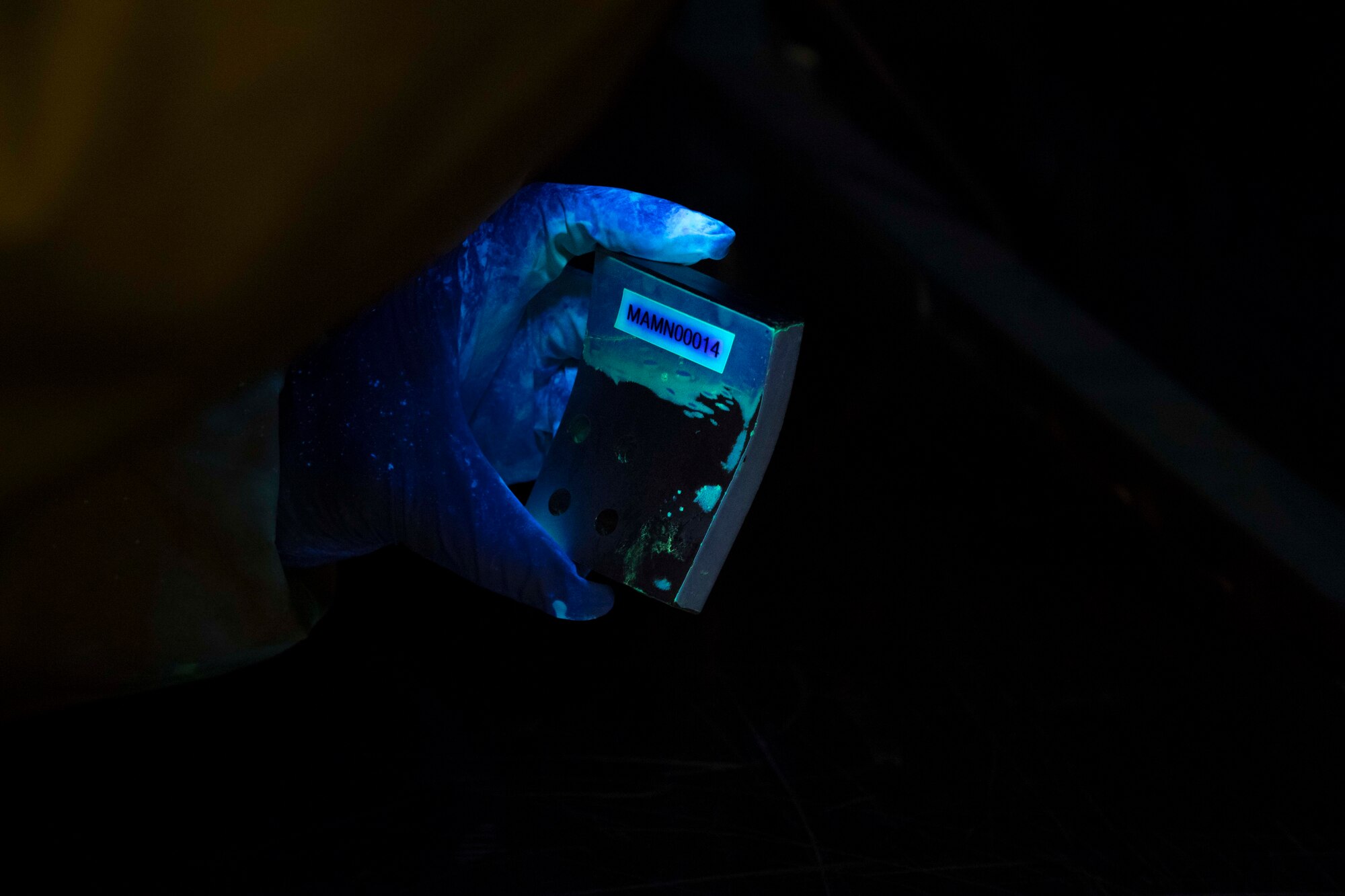 A maintainer with the 6th Maintenance Squadron nondestructive inspections (NDI) unit examines an aircraft part at MacDill Air Force Base, Florida, June 4, 2021.