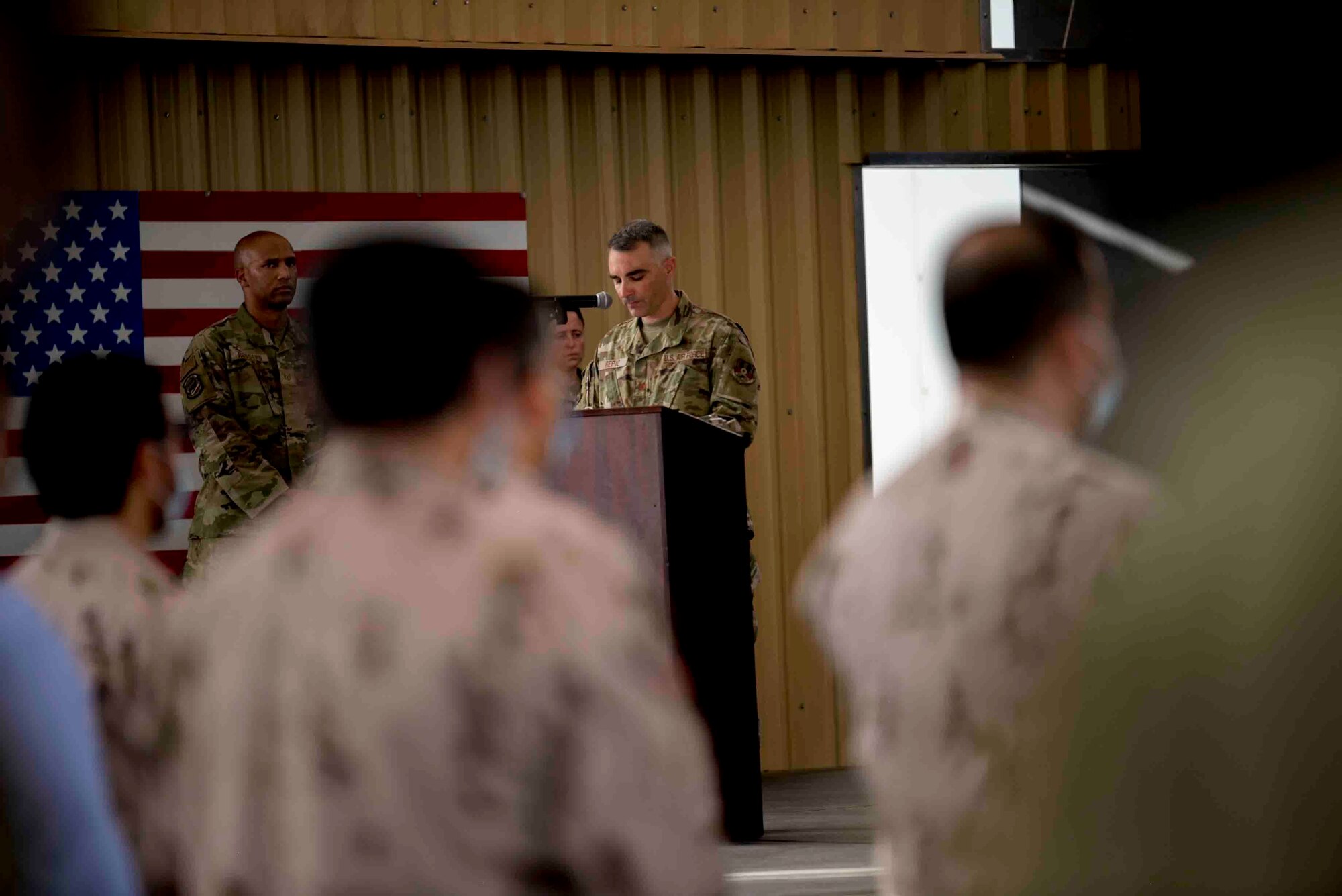 U.S. Air Force Brig. Gen. Larry Broadwell, outgoing commander, passes command of the 380th Air Expeditionary Wing to Brig. Gen. Andrew Clark, incoming commander, during a change of command ceremony at Al Dhafra Air Base, United Arab Emirates, June 8, 2021. The change of command ceremony is a military tradition that represents a formal transfer of authority and responsibility for a unit from one commanding officer to another.