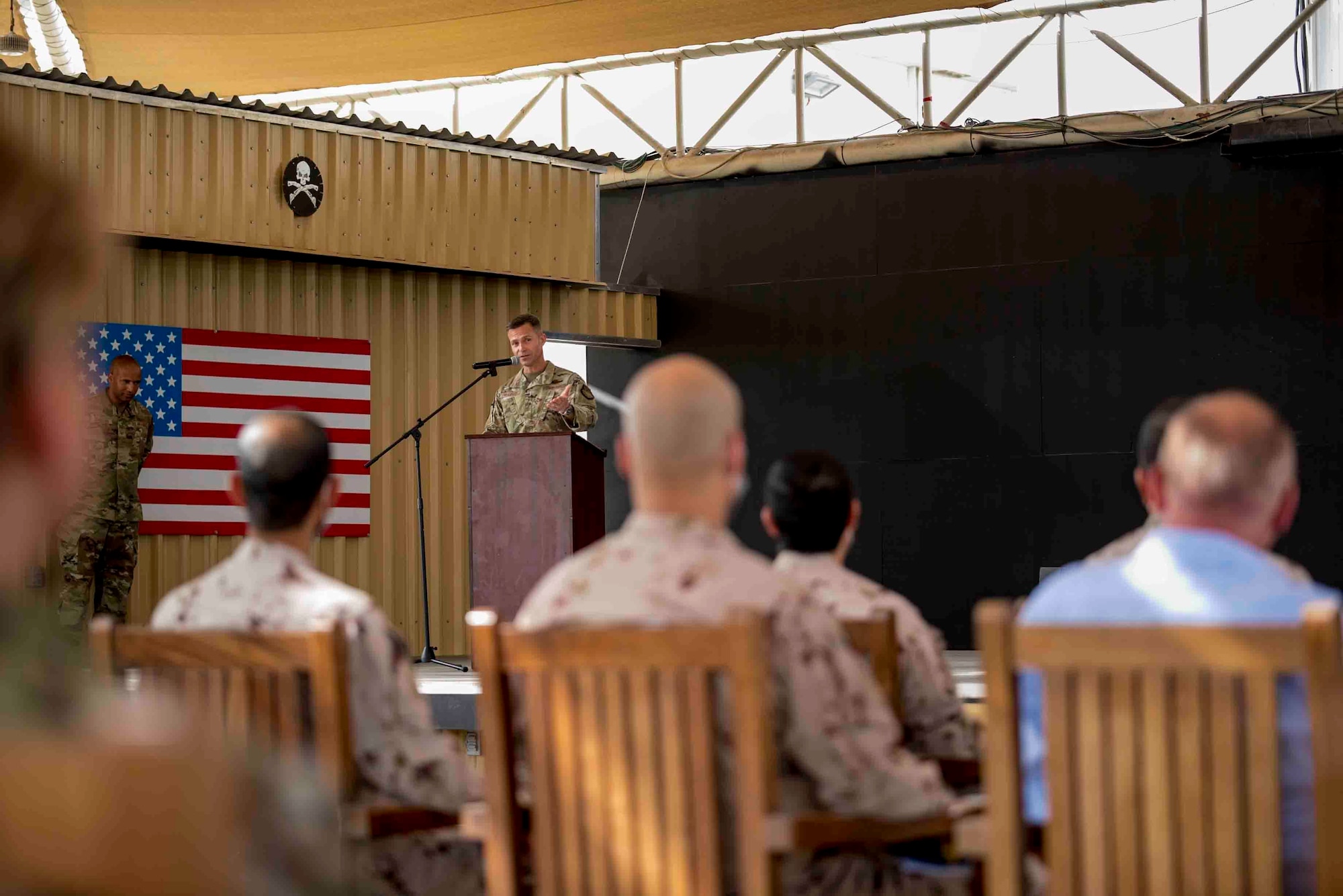 U.S. Air Force Brig. Gen. Larry Broadwell, outgoing commander, passes command of the 380th Air Expeditionary Wing to Brig. Gen. Andrew Clark, incoming commander, during a change of command ceremony at Al Dhafra Air Base, United Arab Emirates, June 8, 2021. The change of command ceremony is a military tradition that represents a formal transfer of authority and responsibility for a unit from one commanding officer to another.