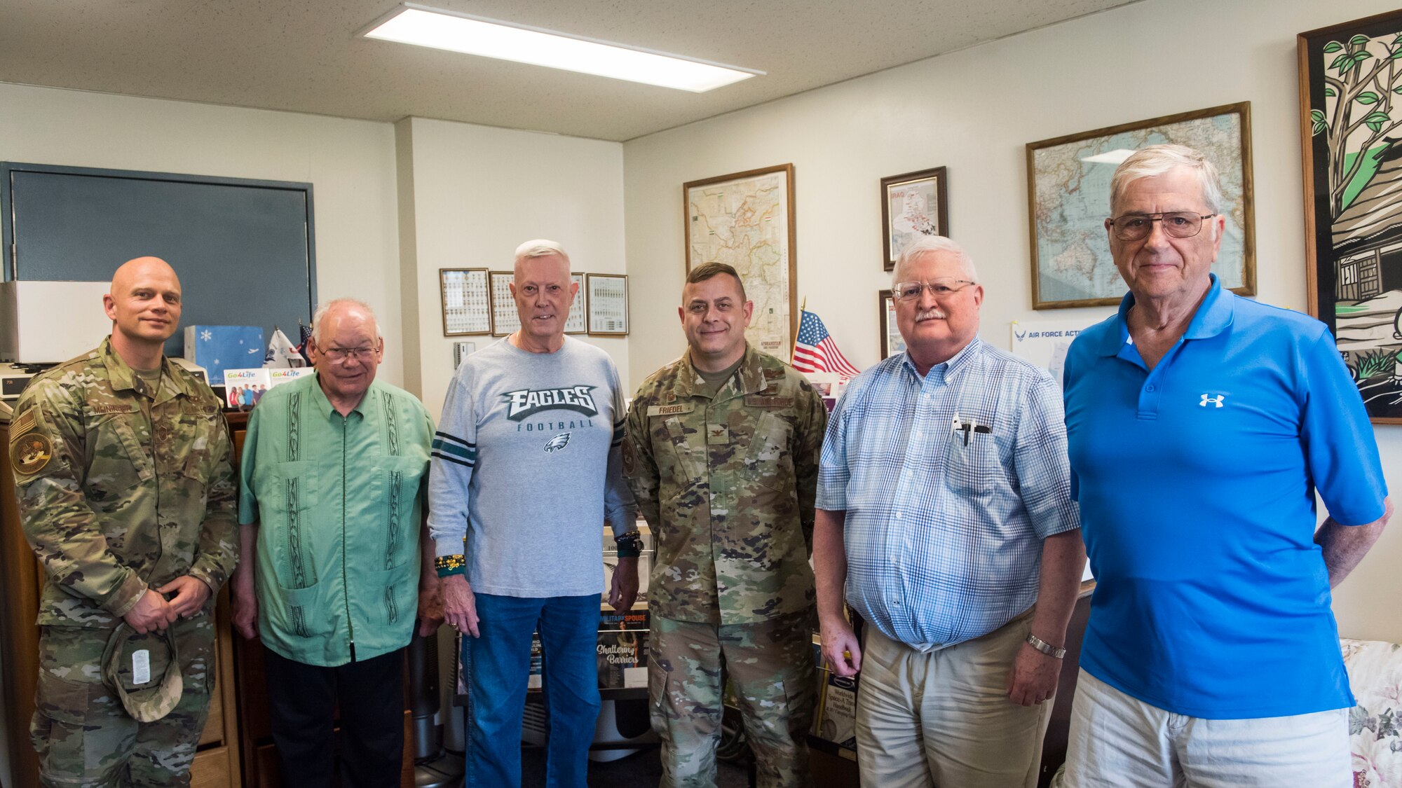 U.S. Air Force members pose for a group photo with retired military members.