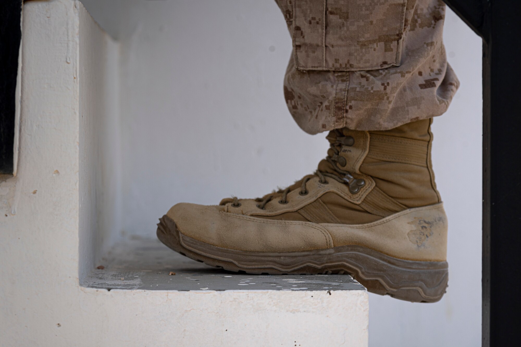A photo of a Marine climbing stairs