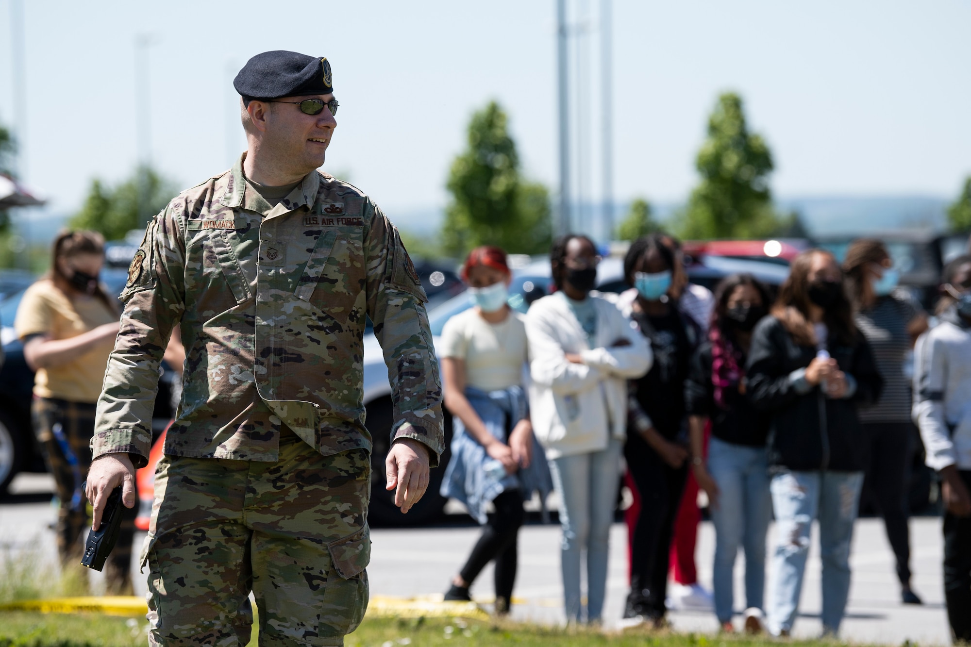 U.S. Air Force Security Forces Airman demonstrates taser techniques to onlookers.