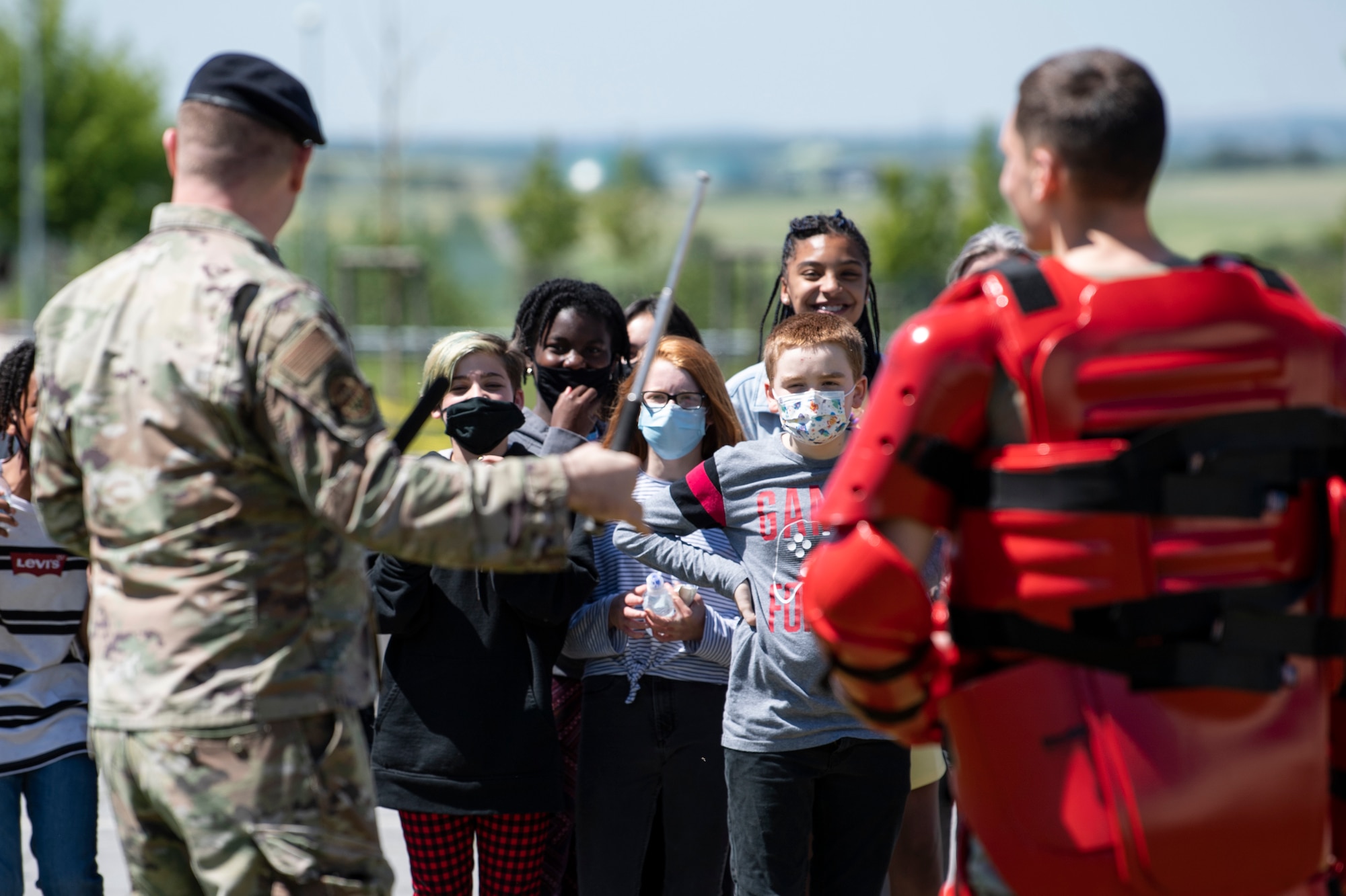 U.S. Air Force Airmen demonstrate advance baton techniques to onlookers.
