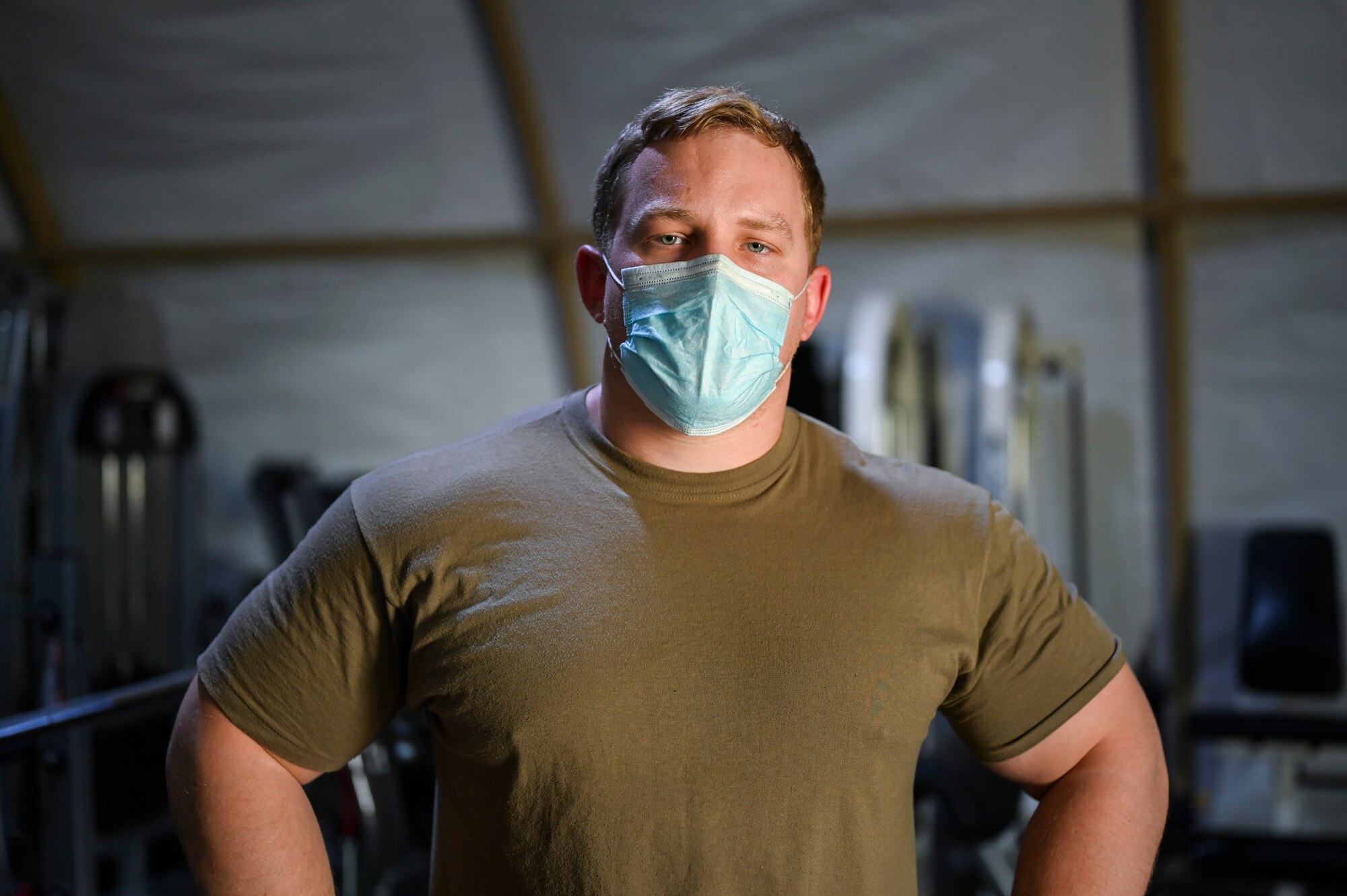 A photo of an Airman lifting weights.