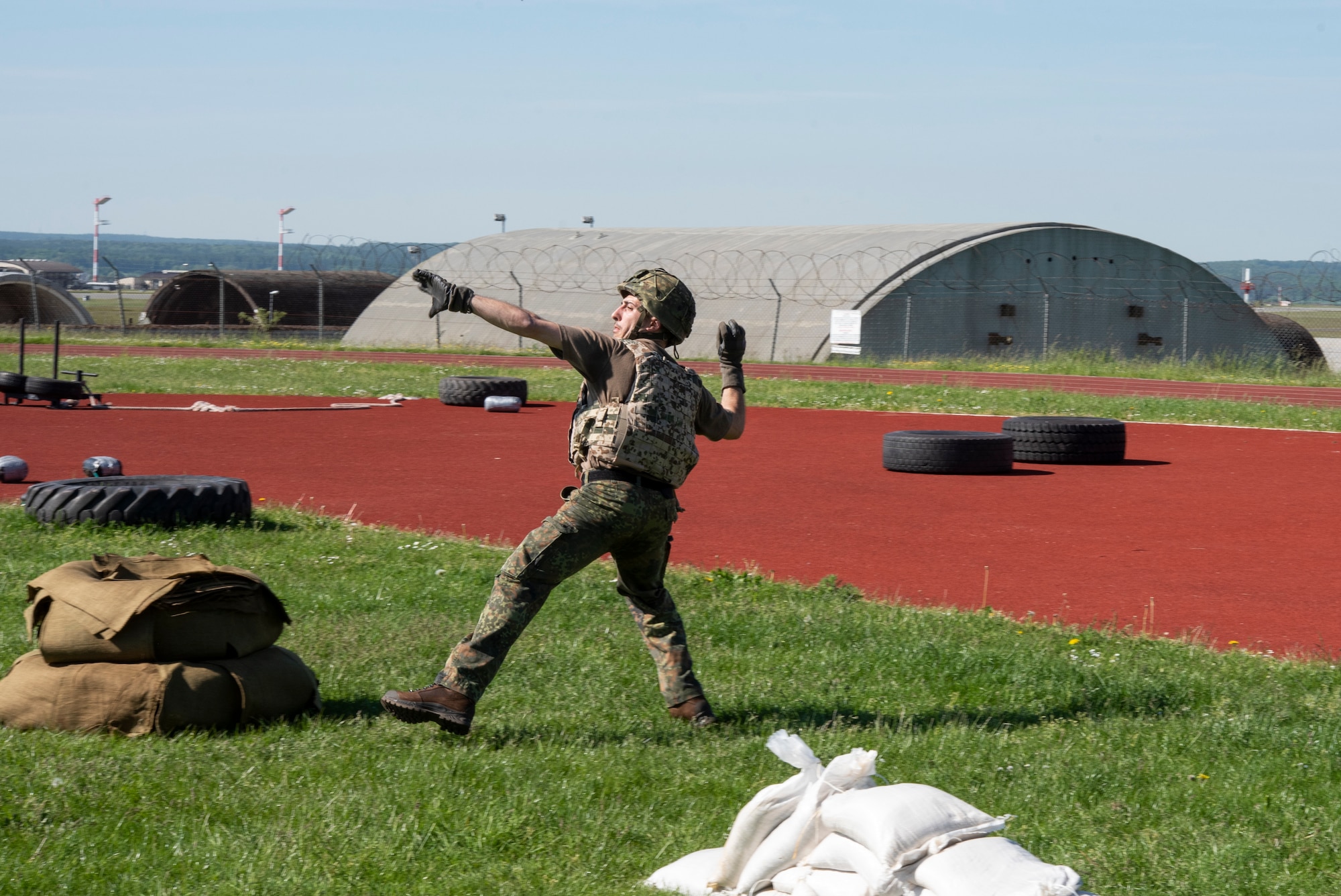 A member of the German Bundeswehr Military Police throws a non-explosive training grenade as part of the Defender Challenge at Spangdahlem Air Base, Germany, June 2, 2021.