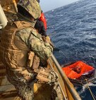 210608-N-N0748-1010 GULF OF ADEN (June 8, 2021) – Master-at-Arms 2nd Class Michael Garcia, assigned to Embarked Security Intelligence Team 11, deployed with Commander, Task Force (CTF) 56, aboard the Military Sealift Command fleet replenishment oiler USNS Patuxent (T-AO 201), relays information on a radio during rescue operations for the crew members of a motor vessel Falcon Line, which sank in the Gulf of Aden, June 8. Patuxent is deployed to the U.S. 5th Fleet area of operations in support of naval operations to ensure maritime stability and security in the Central Region, connecting the Mediterranean and Pacific through the western Indian Ocean and three strategic choke points. (U.S. Navy photo by Electronics Technician 3rd Class Joshua Mazon)