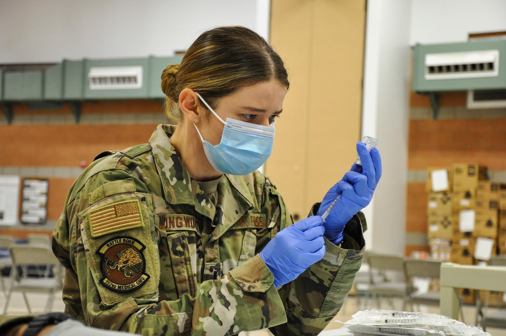 Nevada Air National Guard 1st Lt. Caleena Longworth with Joint Task Force 17 prepares a syringe with the Moderna vaccine at the Las Vegas Readiness Center, Wednesday, Jan. 27, 2021 in Las Vegas, Nevada. Longworth has vaccinated 4,500 people.
