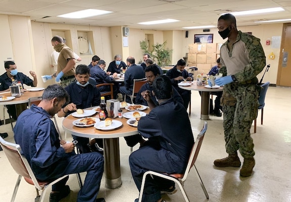 Gunner’s Mate 1st Class Magezi Johnson and Master-at-Arms 3rd Class Gurney White, assigned to Embarked Security Intelligence Team 11, deployed with Commander, Task Force (CTF) 56, aboard the Military Sealift Command fleet replenishment oiler USNS Patuxent (T-AO 201), serve hot meals to rescued crew members from motor vessel Falcon Line, while underway in the Gulf of Aden, June 8.