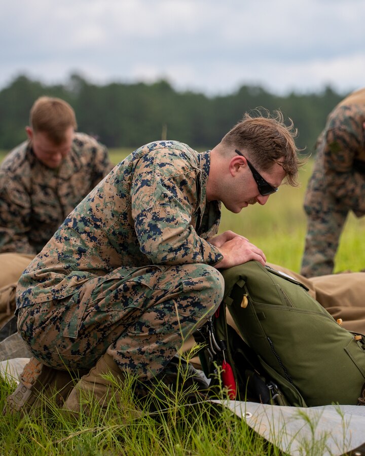 Marines with 3rd Force Reconnaissance Company, 4th Marine Division, prepare for freefall and low level static line jump training at Camp Shelby, Mississippi, on June 3, 2021. The purpose of this exercise is to reinforce the Marines' technique and proficiency on air to ground insertion in order to achieve unit readiness for rapid deployment. (U.S. Marine Corps photo by Lance Cpl. David Intriago)