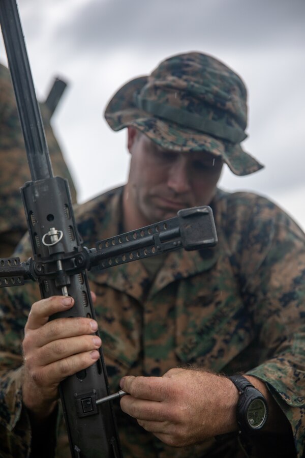 A Marine with 3rd Force Reconnaissance Company, 4th Marine Division, assembles his rifle during sniper training at Camp Shelby, Mississippi, on June 6, 2021. The Marines trained with the M107 semi-automatic long-range sniper rifle, an anti-materiel rifle that fires .50 caliber ammunition out to a maximum effective range of 2000 meters. (U.S. Marine Corps photo by Lance Cpl. David Intriago)