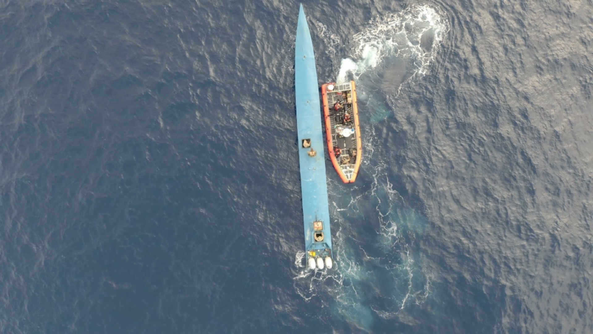 Coast Guard Cutter Active crew members and members with the Coast Guard Pacific Tactical Law Enforcement Team board a suspected drug smuggling vessel in the Easter Pacific Ocean, May 5, 2021. The Active is a 210-foot medium endurance cutter, commissioned in 1966 and homeported in Port Angeles, Washington. (U.S. Coast Guard courtesy photo)