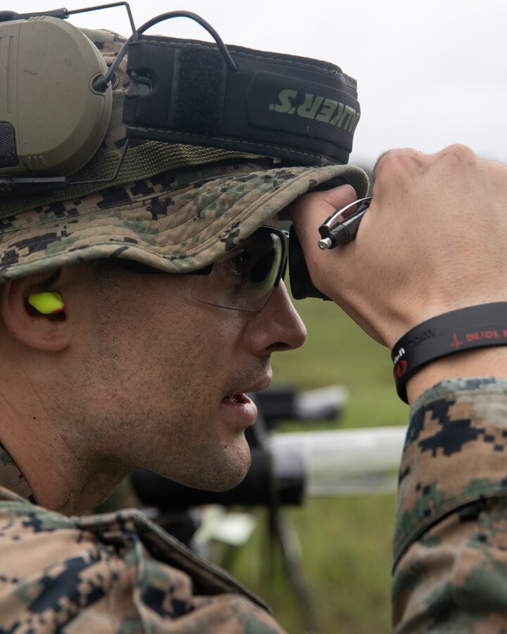 A Marine with 3rd Force Reconnaissance Company, 4th Marine Division, reviews a Marine's shot groups with a spotter during sniper training at Camp Shelby, Mississippi, on June 6, 2021. The Marines trained with the M107 semi-automatic long-range sniper rifle, an anti-materiel rifle that fires .50 caliber ammunition out to a maximum effective range of 2000 meters. (U.S. Marine Corps photo by Lance Cpl. David Intriago)