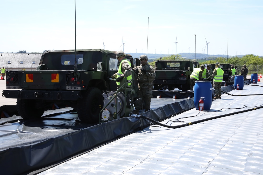 Soldiers from the 1st Inland Cargo Transfer Company, 39th Movement Control Battalion, showcase the new Convoy Support Center kit at Baumholder, Germany, to demonstrate the CSC's capabilities to leadership of the 21st Theater Sustainment Command. The 1st ICTC received 10 CSC kits. These kits consist of fueling system, operations center, traffic control, solar lighting, and flooring.