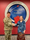 Col. Marvin Griffin, Huntsville Center commander, presents Rachel Ray, Engineering Directorate administrative officer, a commander’s coin and safety coin. in recognition of her 13 years of service to the Safety Program.