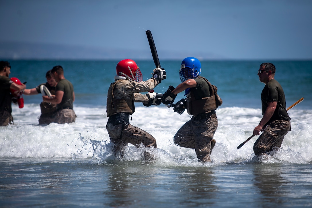 U.S. Marines with Marine Corps Air Station Miramar spar in Pacific Ocean during the Martial Arts Instructors Course 148-21 culminating event on Naval Air Station North Island, San Diego, Calif., May 27, 2021. The culminating event is the last event of the 3-week-long course and tests the martial arts skills, mental discipline, warrior spirit, and warfighting mentality of the future Marine Corps Martial Arts Program instructors.