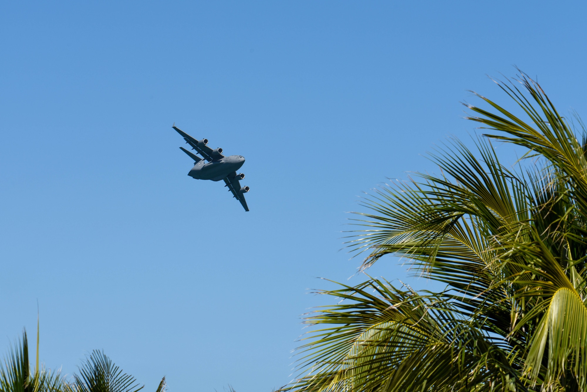 A C-17 Globemaster III, piloted by members of the C-17 West Coast Demo Team from Joint Base Lewis-McChord, Washington, flies through the skies above Miami Beach, Florida, May 29, 2021. The demonstration was a part of the National Salute to Our Heroes Hyundai Air and Sea Show, which had over 100,000 viewers both days of the show. (U.S. Air Force photo by Senior Airman Mikayla Heineck)