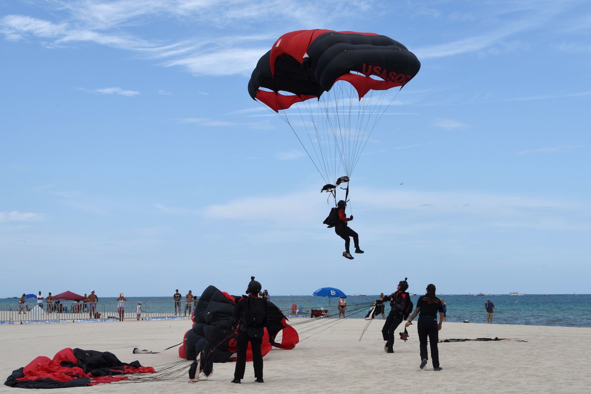 The British Army Red Devils Army Display Team lands on Miami Beach, Florida, after parachuting out of a C-17 Globemaster III piloted by the C-17 West Coast Demo Team from Joint Base Lewis-McChord, Washington, May 30, 2021. This air drop and parachuting demonstration was a part of the National Salute to Our Heroes Hyundai Air and Sea Show in Miami, which had over 100,000 viewers both days of the show. (U.S. Air Force photo by Senior Airman Mikayla Heineck)