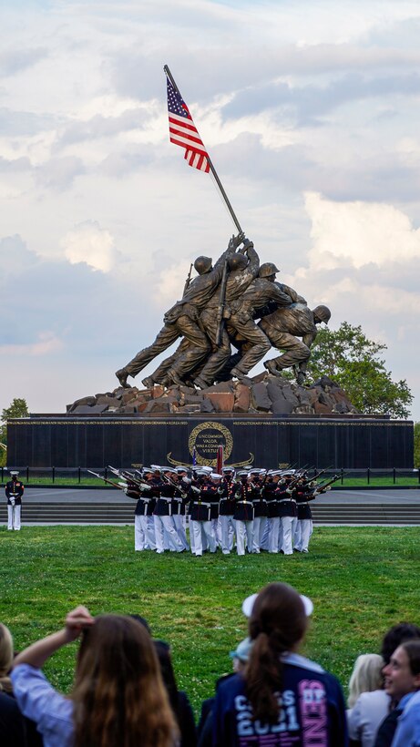Marines with the Silent Drill Platoon execute their “bursting bomb” sequence during a Tuesday Sunset Parade at the Marine Corps War Memorial, Arlington, Va., June 8, 2021.