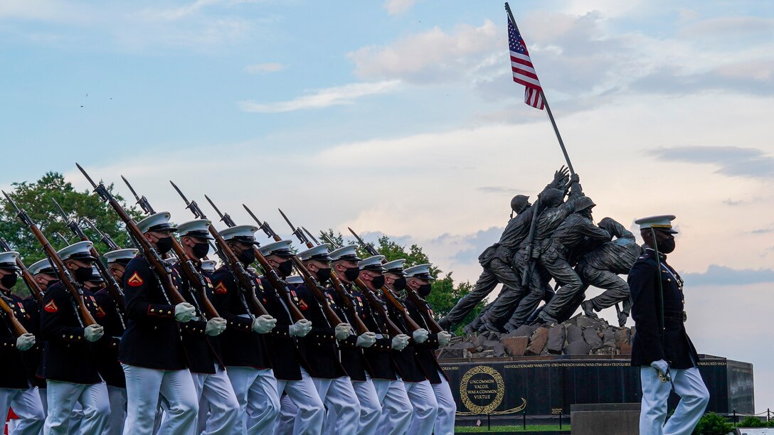 Marines with the Silent Drill Platoon march for “Pass in Review” during a Tuesday Sunset Parade at the Marine Corps War Memorial, Arlington, Va., June 8, 2021. The hosting official for the evening was Mr. Robert D. Hogue, counsel for the Commandant of the Marine Corps, and The Honorable Kirsten E. Gillibrand, U.S. Senator for New York, was the guest of honor. (U.S. Marine Corps photo by Sgt. Jason Kolela)