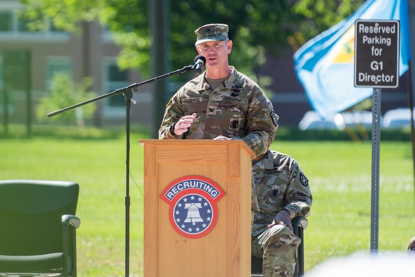 one man in uniform standing at a podium.