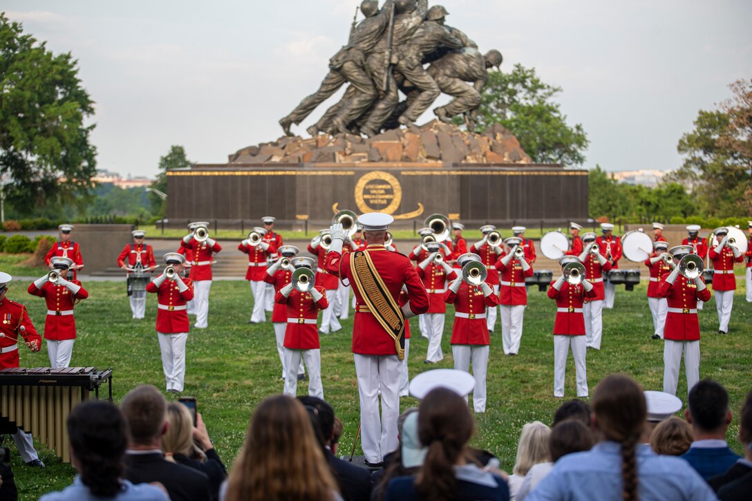 Master GySgt Keith Martinez, drum major, “The Commandant’s Own,” U.S. Marine Drum and Bugle Corps, directs Marines during a Tuesday Sunset Parade at the Marine Corps War Memorial, Arlington, Va., June 8, 2021. The hosting official for the evening was Mr. Robert D. Hogue, counsel for the Commandant of the Marine Corps, and The Honorable Kirsten E. Gillibrand, U.S. Senator for New York, was the guest of honor. (U.S. Marine Corps photo by Lance Cpl. Mark Morales)