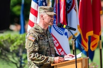 one man in uniform standing at a podium.