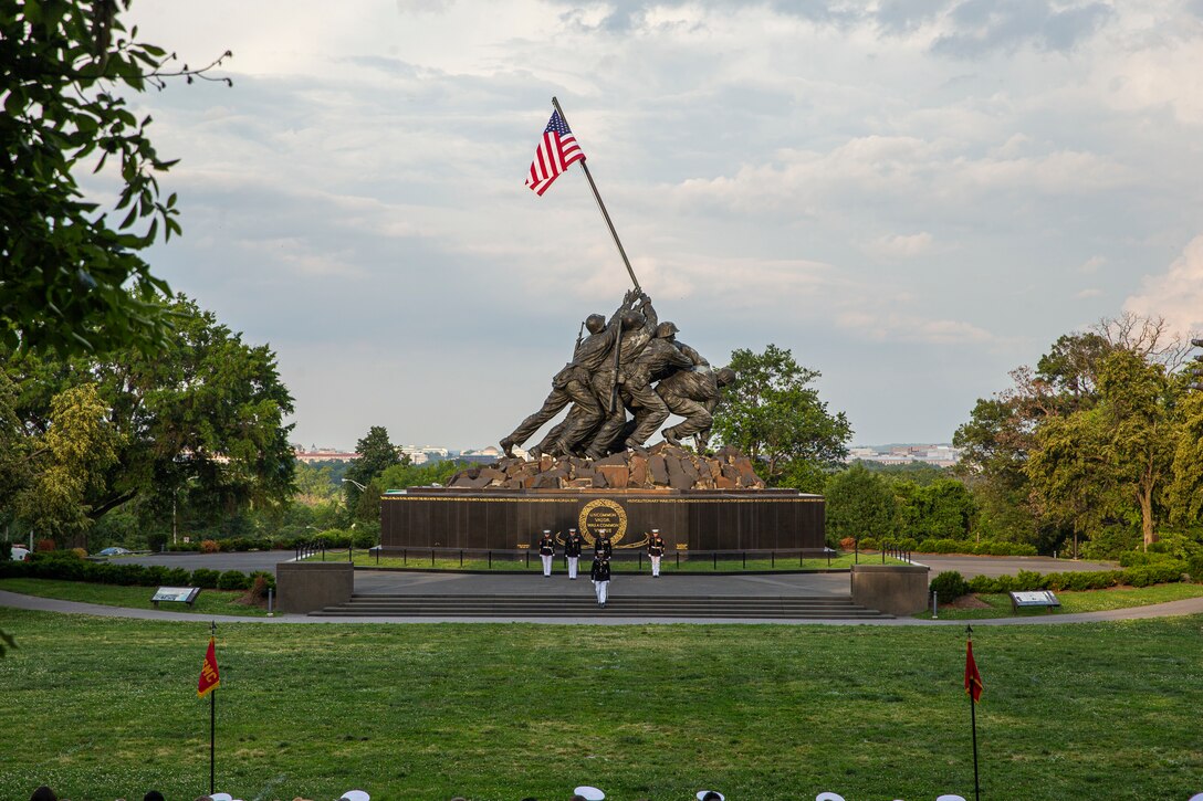 Marines with the parade staff march into position during a Tuesday Sunset Parade at the Marine Corps War Memorial, Arlington, Va., June 8, 2021.