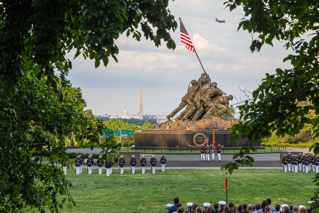 Marines with Marine Barracks Washington stand in formation during a Tuesday Sunset Parade at the Marine Corps War Memorial, Arlington, Va., June 8, 2021. The hosting official for the evening was Mr. Robert D. Hogue, counsel for the Commandant of the Marine Corps, and The Honorable Kirsten E. Gillibrand, U.S. Senator for New York, was the guest of honor. (U.S. Marine Corps photo by Lance Cpl. Tanner D. Lambert)