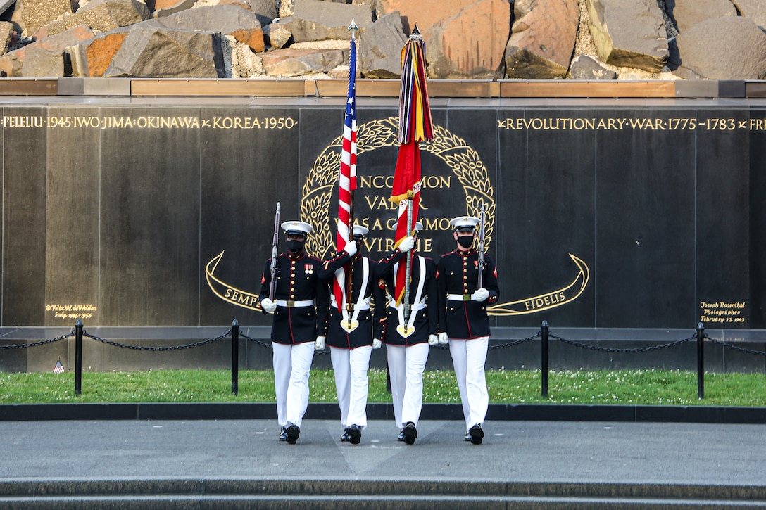 Marines with the Official U.S. Marine Corps Color Guard march into position during a Tuesday Sunset Parade at the Marine Corps War Memorial, Arlington, Va., June 8, 2021. The hosting official for the evening was Mr. Robert D. Hogue, counsel for the Commandant of the Marine Corps, and The Honorable Kirsten E. Gillibrand, U.S. Senator for New York, was the guest of honor. (U.S. Marine Corps photo by Lance Cpl. Allen Sanders)