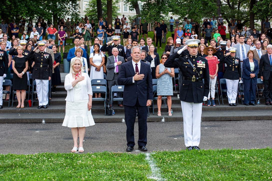 The Honorable Kirsten E. Gillibrand, left, U.S. Senator for New York, The Honorable Mr. Robert D. Hogue, center, counsel for the Commandant of the Marine Corps, and Col. Teague A. Pastel, commanding officer, Marine Barracks Washington, stand for honors during a Tuesday Sunset Parade at the Marine Corps War Memorial, Arlington, Va., June 8, 2021. Hogue was the hosting official for the evening and Gillibrand was the guest of honor. (U.S. Marine Corps photo by Lance Cpl. Allen Sanders)