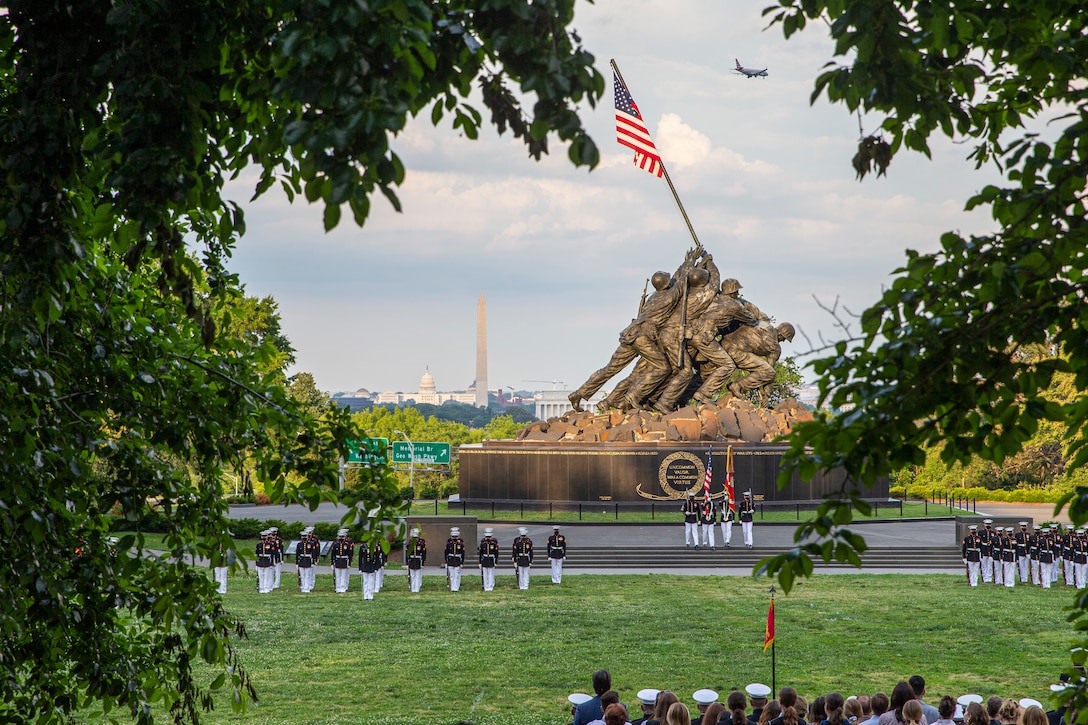Marines with Marine Barracks Washington stand in formation during a Tuesday Sunset Parade at the Marine Corps War Memorial, Arlington, Va., June 8, 2021. The hosting official for the evening was Mr. Robert D. Hogue, counsel for the Commandant of the Marine Corps, and The Honorable Kirsten E. Gillibrand, U.S. Senator for New York, was the guest of honor. (U.S. Marine Corps photo by Lance Cpl. Tanner D. Lambert)