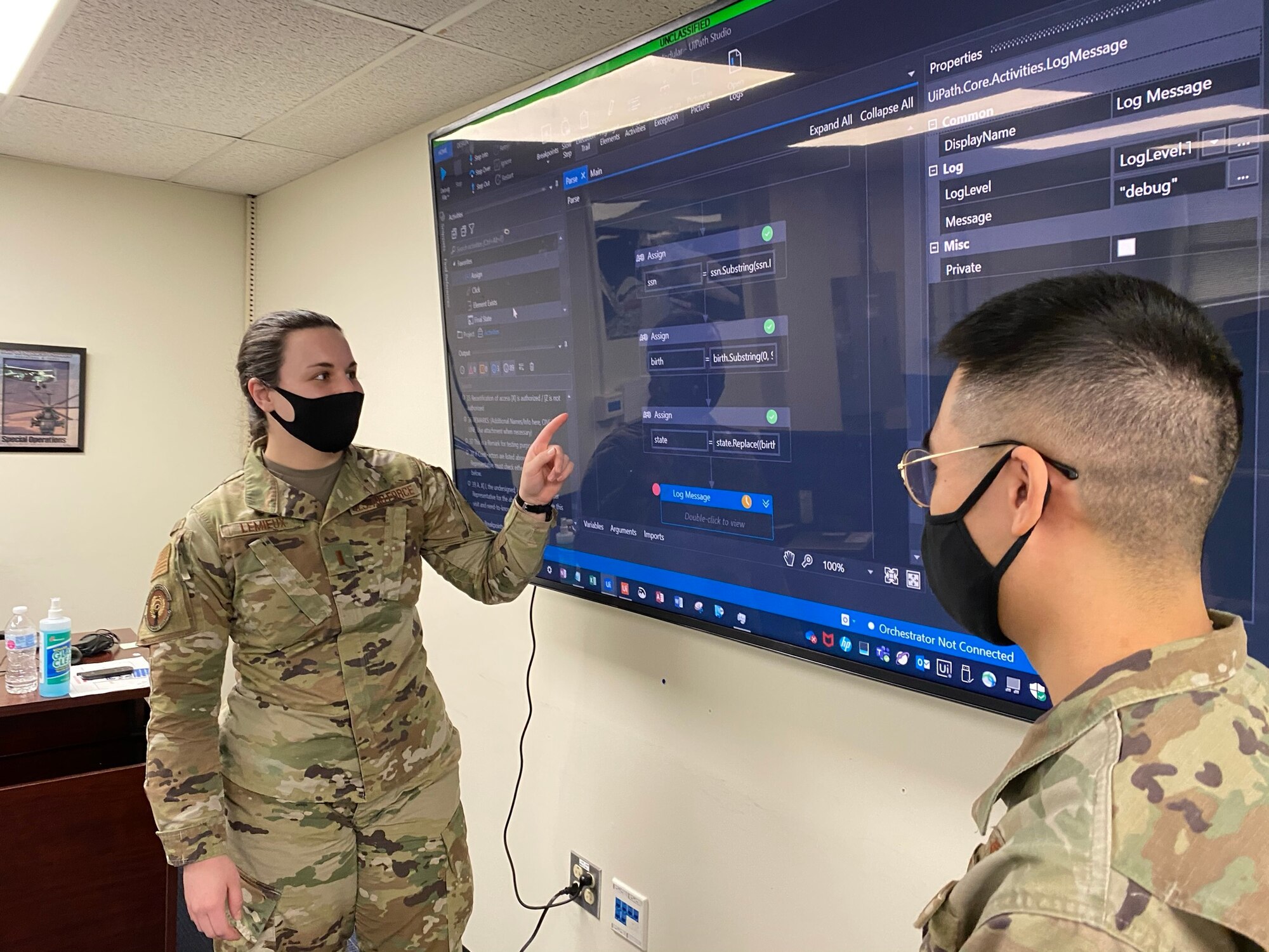 Second Lt. Arianna Lemieux examines UiPath's user interface and data processing steps with 1st Lt. Luke Chen in the collaborative classroom.
